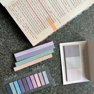 May include: A set of colorful sticky notes with a grid pattern. The notes are arranged in a color palette, with shades of blue, purple, pink, and green. The notes are labeled "Color Palette Sticky" and "A miniature set of colorful sticky notes".