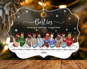May include: A clear, scalloped-edge acrylic ornament featuring the text Besties Always better together. The design shows ten illustrated figures in winter sweaters and hats, with the names Clara, Olivia, Amelia, Leilani, Ruby, Rose, Sofia, Chloe, Lyla, Piper and 2026.