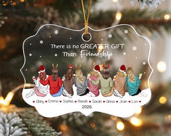 May include: A clear, scalloped-edge acrylic ornament featuring a gold hanging cord. The text reads "There is no GREATER GIFT Than Friendship" above an illustration of eight people with names "Abby, Emma, Sophia, Hanah, Sarah, Anna, Jean, Lori" and "2026".