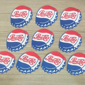 Puede incluir: Diez parches de tapón de botella rojo, blanco y azul con el texto "Pepsi Cola" en una fuente azul cursiva.