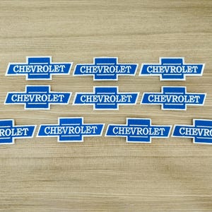 May include: Ten blue and white embroidered patches with the word "CHEVROLET" in white lettering.