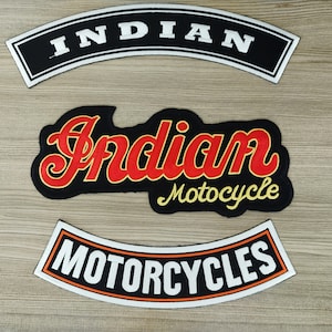May include: Three black and white motorcycle patches. The top patch says "INDIAN" in white letters. The middle patch says "Indian Motorcycle" in red and yellow letters. The bottom patch says "MOTORCYCLES" in white letters.