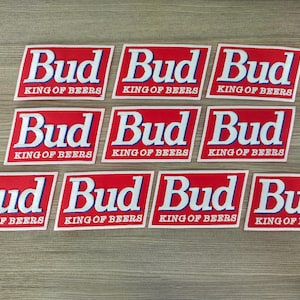 May include: Eight red and white patches with the text "Bud King of Beers" repeated on each patch.