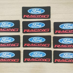 May include: Ten black and blue embroidered patches with the words "Ford Racing" in red and white lettering.