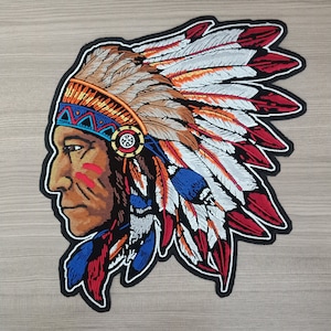 May include: Embroidered patch of a Native American man wearing a headdress with red, white, blue, and orange feathers. The headdress is decorated with geometric patterns.