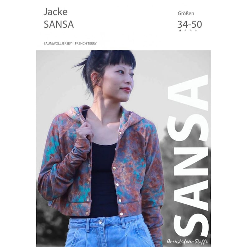 May include: A cropped hooded jacket with a colorful abstract print. The jacket is made of cotton jersey and has a button closure. The model is wearing the jacket with a black tank top and blue jeans. The text "SANSA" is printed on the jacket.