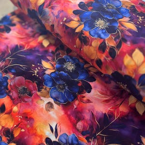 May include: Watercolor floral fabric featuring a vibrant red, orange, and purple background with blue flowers and gold accents.