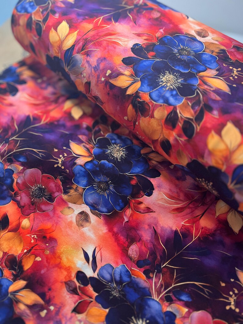 May include: Watercolor floral fabric featuring a vibrant red, orange, and purple background with blue flowers and gold accents.