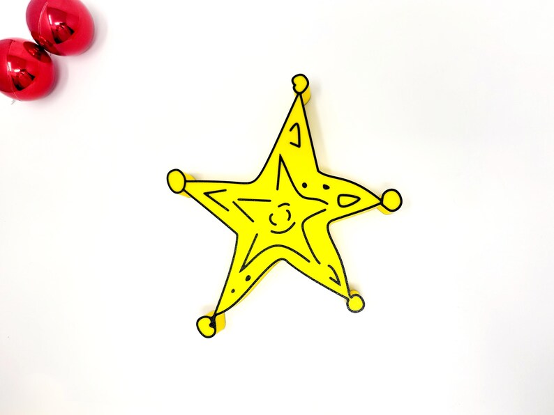 May include: A yellow five-pointed star with black outlines. The star has a simple, hand-drawn style.