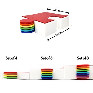 May include: Set of colorful puzzle-shaped coasters in red, orange, yellow, green, blue, indigo, and violet. The coasters are 10 cm wide and 4 cm high.