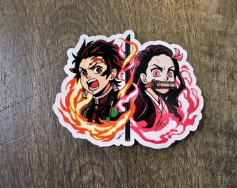 May include: A sticker featuring two anime characters, one with red hair and the other with black hair, both with their mouths covered. The characters are surrounded by flames, one red and one orange.
