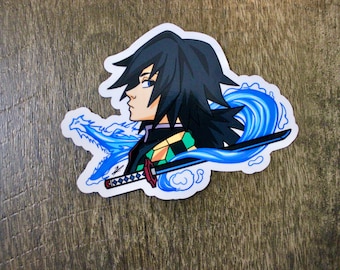 May include: A sticker featuring a cartoon illustration of a character with black hair and a green and black patterned shirt. The character is holding a sword and is surrounded by blue water-like designs.