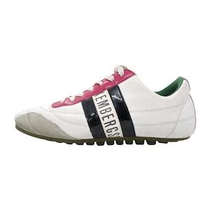 May include: White and pink athletic shoe with a gray toe and green sole. The shoe features a black stripe with the word "Bikkembergs" in white. The laces are white, and the heel is green.