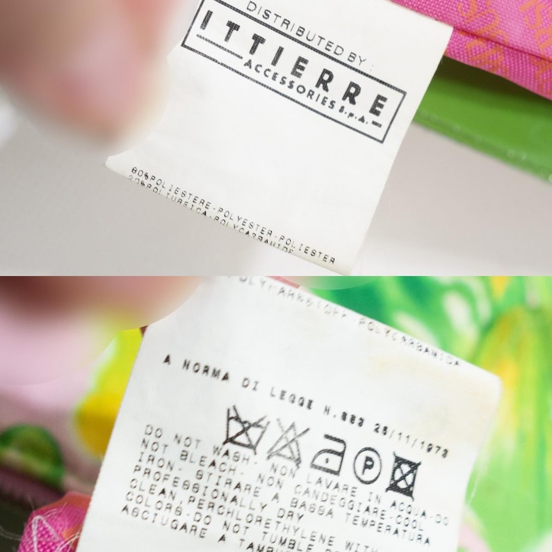 K&ouml;nnte beinhalten: Nahaufnahme von zwei wei&szlig;en Stoffetiketten mit schwarzem Text. Das obere Etikett lautet "DISTRIBUTED BY ITTIERRE ACCESSORIES S.P.A." und listet die Stoffzusammensetzung auf. Das untere Etikett enth&auml;lt Pflegehinweise, einschlie&szlig;lich "DO NOT WASH".