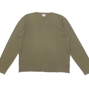 May include: Olive green long-sleeve shirt with a V-neck. The shirt has a simple, minimalist design and is made of a soft, comfortable material. The shirt is laid flat on a white background.
