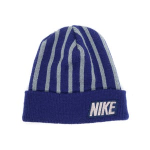 May include: A blue knit beanie with vertical gray stripes. The hat features a folded brim and a white and gray "NIKE" logo patch on the front. The hat is designed for cold weather.