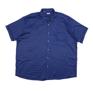 May include: A short-sleeved button-down shirt in a solid dark blue color. The shirt features a standard collar, a single chest pocket on the left side, and a front placket with matching blue buttons. The fabric has a smooth, slightly reflective finish.