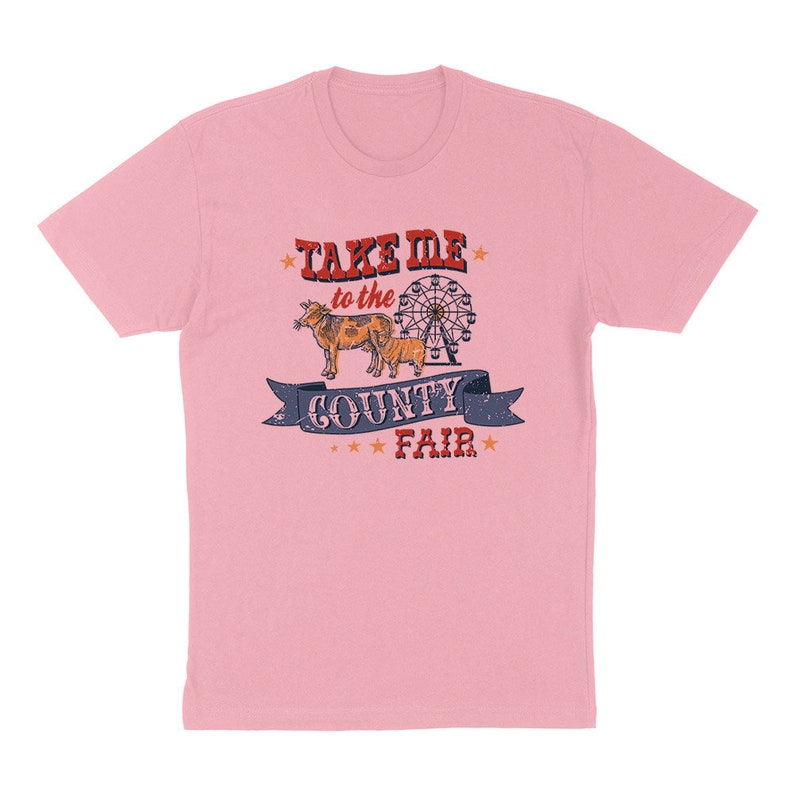 May include: A light pink t-shirt with a graphic design. The design features the text "TAKE ME to the COUNTY FAIR" above a drawing of a cow and a Ferris wheel. The text and images are in red, blue, and brown.