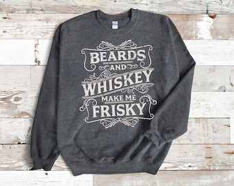 May include: A dark gray sweatshirt with a white graphic print that reads "BEARDS AND WHISKEY MAKE ME FRISKY" in a vintage style font.