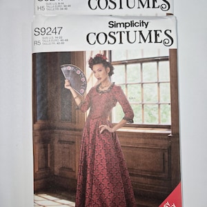 May include: Two Simplicity Costumes sewing pattern packets. The packets feature a woman in a red patterned costume holding a fan. The text on the packets reads "S9247" and "Fantasy & Cosplay Sewing Pattern."