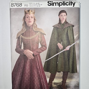 May include: Simplicity sewing pattern featuring medieval costume designs. The pattern includes options for a burgundy dress with gold accents and a green cloak with a hood. Sizes available are U.S. 6-14 and 14-22. The pattern is designed and printed in the USA.