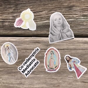 May include: A set of five religious stickers featuring images of Mary and Jesus. The stickers are printed on white paper and have a glossy finish. The stickers include images of Mary, Jesus, and a chalice with a host. The stickers also include the text "Co-redemptrix Mediatrix Advocate".