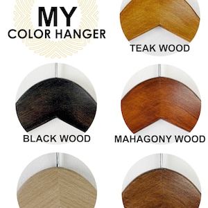 May include: Six wooden hangers in different wood finishes: teak, black, mahogany, natural, brown. The hangers are all the same shape and size. The text "MY COLOR HANGER" is displayed above the hangers.