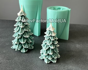 May include: Two green silicone molds for making Christmas tree candles. The molds are in the shape of a Christmas tree. There are two finished candles, one large and one small, made from the molds.