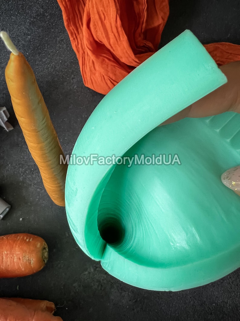 May include: A close-up of a light teal silicone mold, shaped like a carrot. A realistic carrot and a piece of orange fabric are also visible. The text "MilovFactoryMoldUA" is printed on the image.
