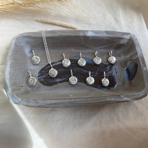 Handmade initial stamped necklace made from recycled sterling silver with hand stamped personalisation