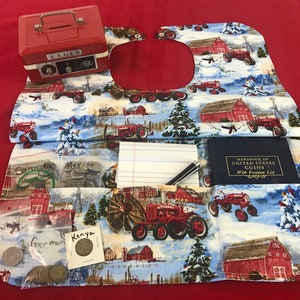 May include: A red fabric coin purse with a winter farm scene featuring red barns, snow-covered trees, and red tractors. The purse has multiple pockets and includes a small red metal vault, a notebook, a pen, a blue book titled "Handbook of United States Coins with Premium List", and several small bags of coins labeled "Canada", "Mexico", "China", "Germany", and "Kenya".