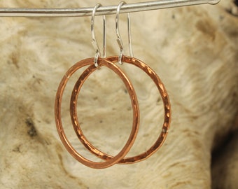 Medium Copper hoop earrings with sterling silver ear wires with paddle detail.  Hammered Texture. 1 inch diameter.