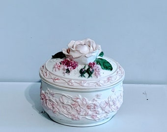 Vintage pink and white jewelry box embossed with flowers