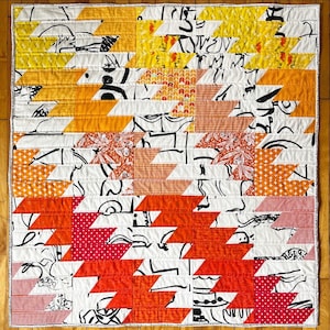 Bright and colourful, red, orange, yellow zig zag modern graphic quilt