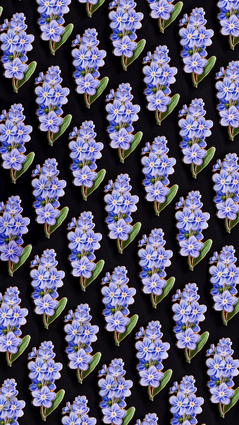 May include: A repeating pattern of blue forget-me-not flowers with gold accents on a black background.