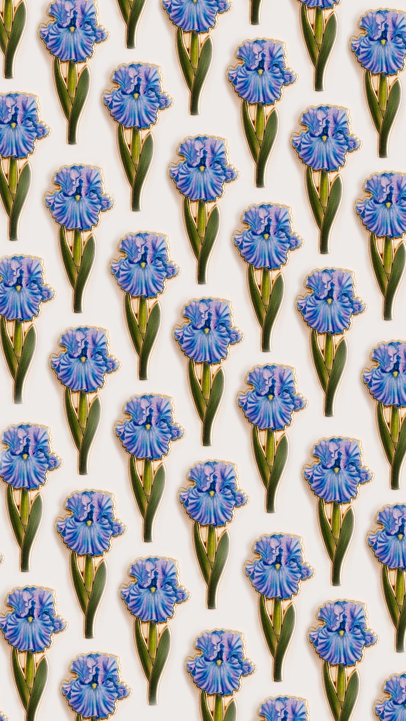 May include: A white background with a repeating pattern of blue and purple iris flowers with gold accents. The flowers are arranged in a grid pattern.