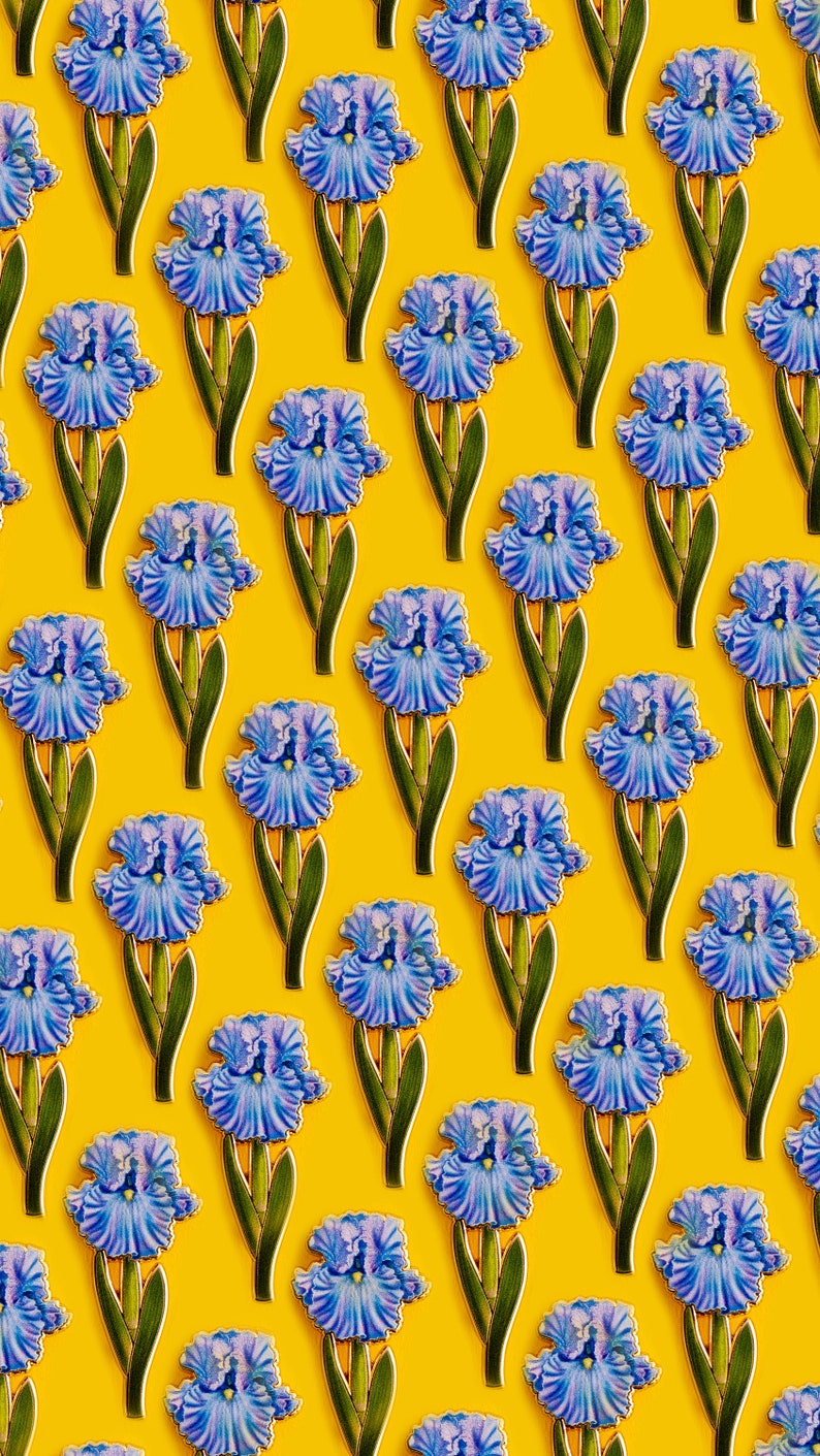 May include: A repeating pattern of blue iris flowers on a yellow background. The flowers are stylized and have a vintage look.