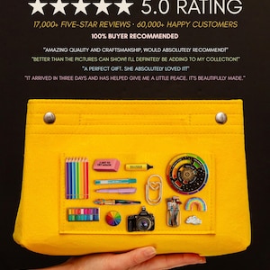 May include: A vibrant yellow felt organiser bag, showcasing a selection of stationery items such as pencils, pens, and a camera. The bag has a 5-star rating and is buyer recommended.