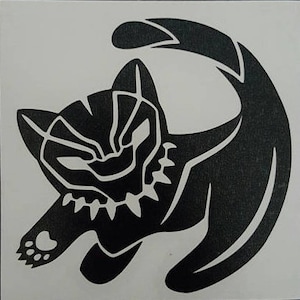 May include: Black silhouette of a cat with a paw print on its front leg. The cat is curled up in a circle with its tail wrapped around its body. The cat's face is stylized to resemble a Black Panther.