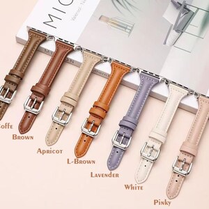 May include: Eight different colored leather watch bands for an Apple Watch. The bands are in the colors coffee, brown, apricot, light brown, lavender, white, and pinky.