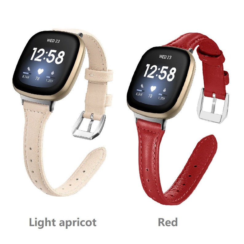 May include: Two leather watch bands for a smartwatch. The band on the left is light apricot and the band on the right is red. Both bands have a buckle closure.