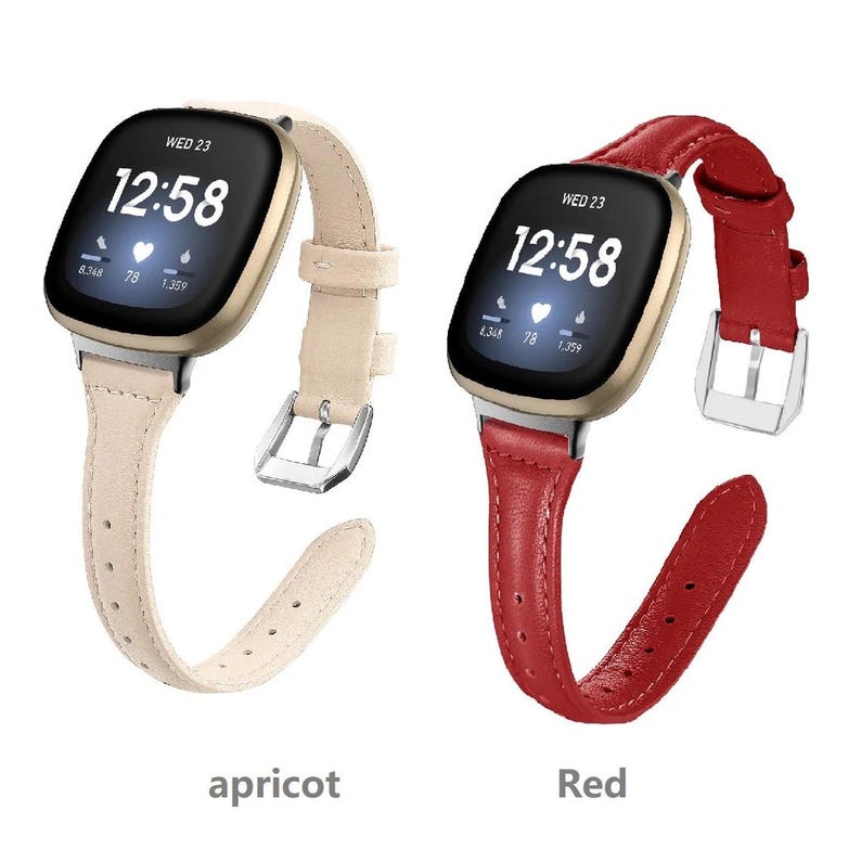 May include: Two smartwatch bands in different colors. The band on the left is apricot and the band on the right is red. Both bands have a gold-colored watch face with the time displayed as 12:58. The watch face also displays the day of the week, which is Wednesday, and the date, which is 23. The watch face also displays the heart rate, which is 78, and the steps taken, which is 1,359.