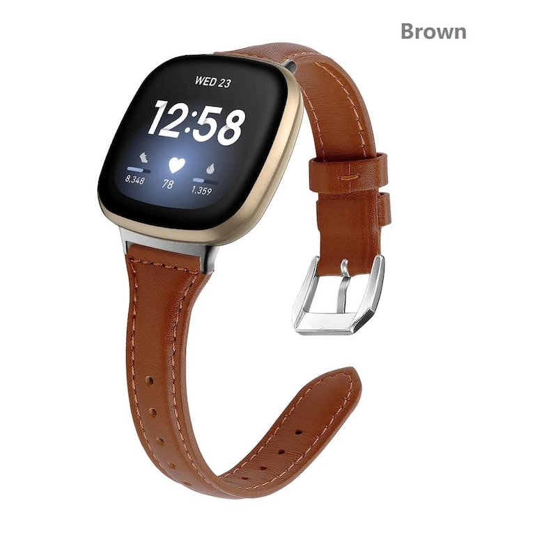 May include: Brown leather watch band with a silver buckle. The band is compatible with a smartwatch with a square face. The watch face displays the time, date, and heart rate.