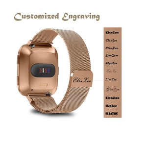 May include: A rose gold smartwatch with a metal mesh band. The band has a personalized engraving that reads "Elsa Zoe".