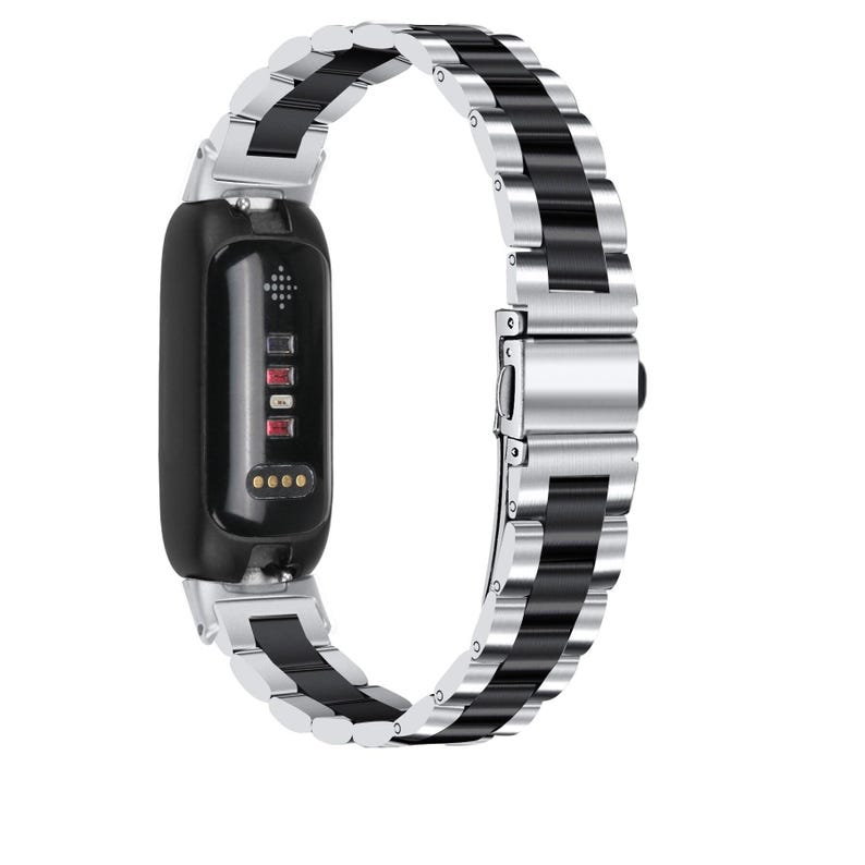 May include: A black fitness tracker with a silver and black metal band. The band features alternating silver and black links. The tracker has a black screen and a series of red and gold indicator lights.