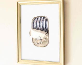 May include: A framed wall art piece featuring a detailed illustration of an open metal tin filled with five small silver fish. The artwork is encased in a rectangular gold-colored frame, presenting a clear view of the sardines inside the container.