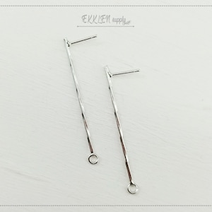 Può includere: Due perni per orecchini in argento con un design a filo ritorto e un piccolo anello in basso.