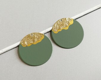 May include: Two round green and gold earrings. The earrings are painted green with a gold accent on the top half.