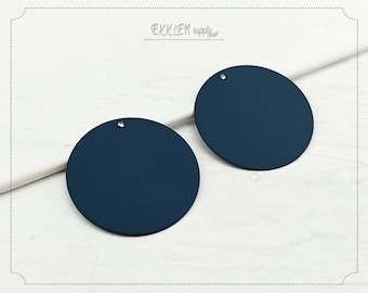 May include: Two dark blue round acrylic circles with a small hole in the center. The circles are approximately 2 inches in diameter.