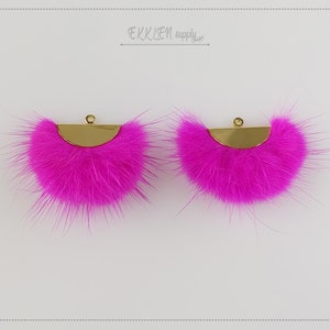May include: Two pink faux fur half-circle embellishments with gold metal backing and a loop for attaching.